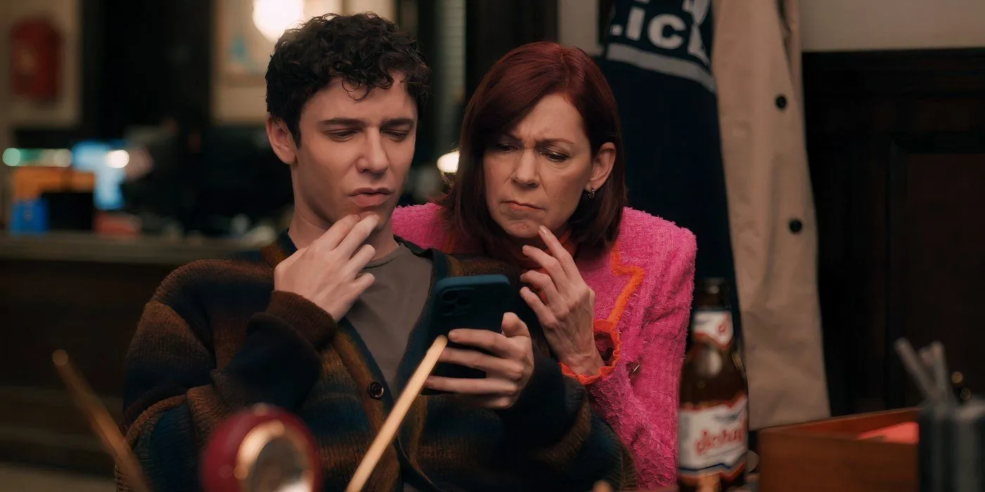 Elsbeth and Ben looking at a phone Elsbeth and Ben looking at a phone