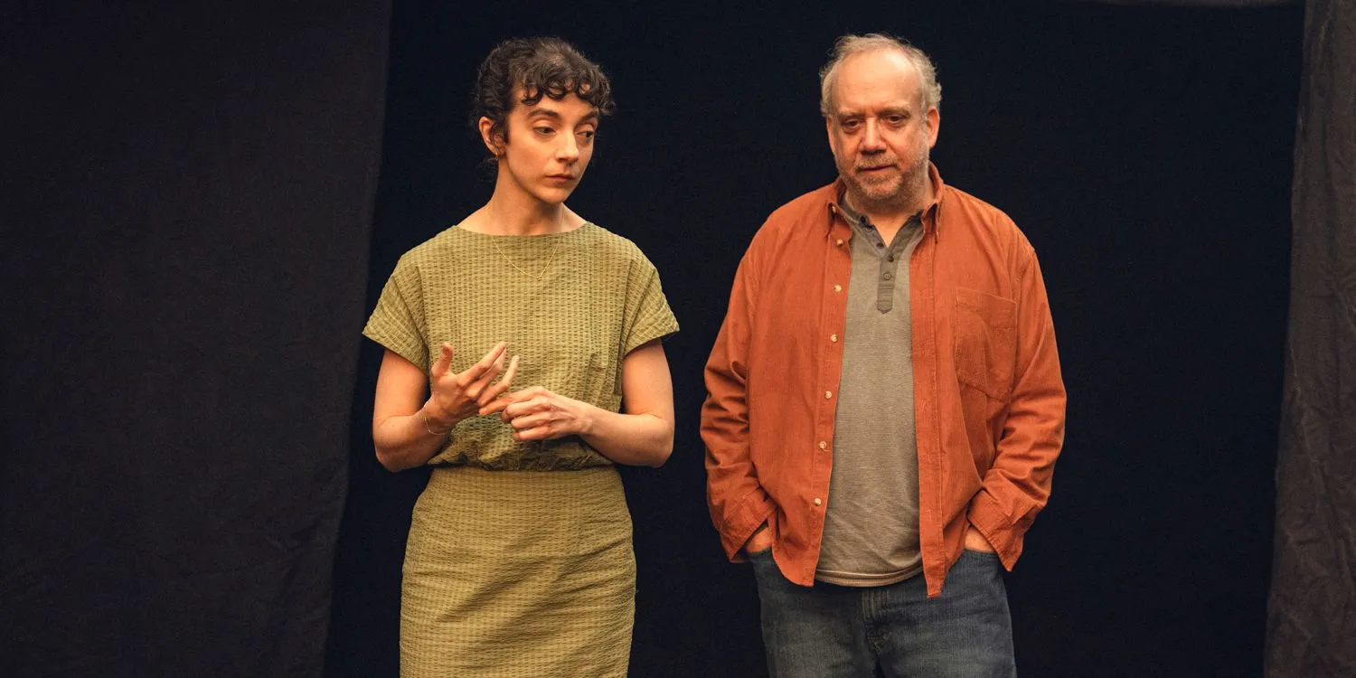 The Guide (Patsy Ferran) and Phillip (Paul Giamatti) walking together in Black Mirror Season 7 Ep 5 The Guide (Patsy Ferran) and Phillip (Paul Giamatti) walking together in Black Mirror Season 7 Ep 5
