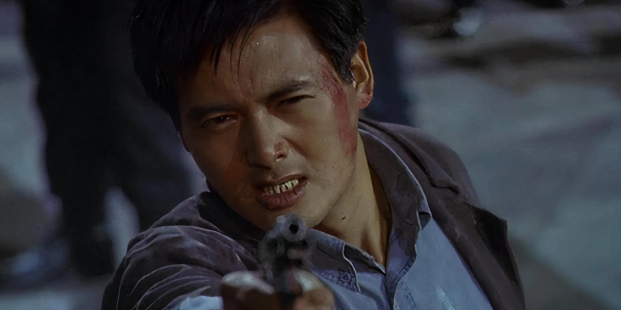 Chow Yun-Fat wears a gritty expression as he points a gun. Chow Yun-Fat wears a gritty expression as he points a gun.