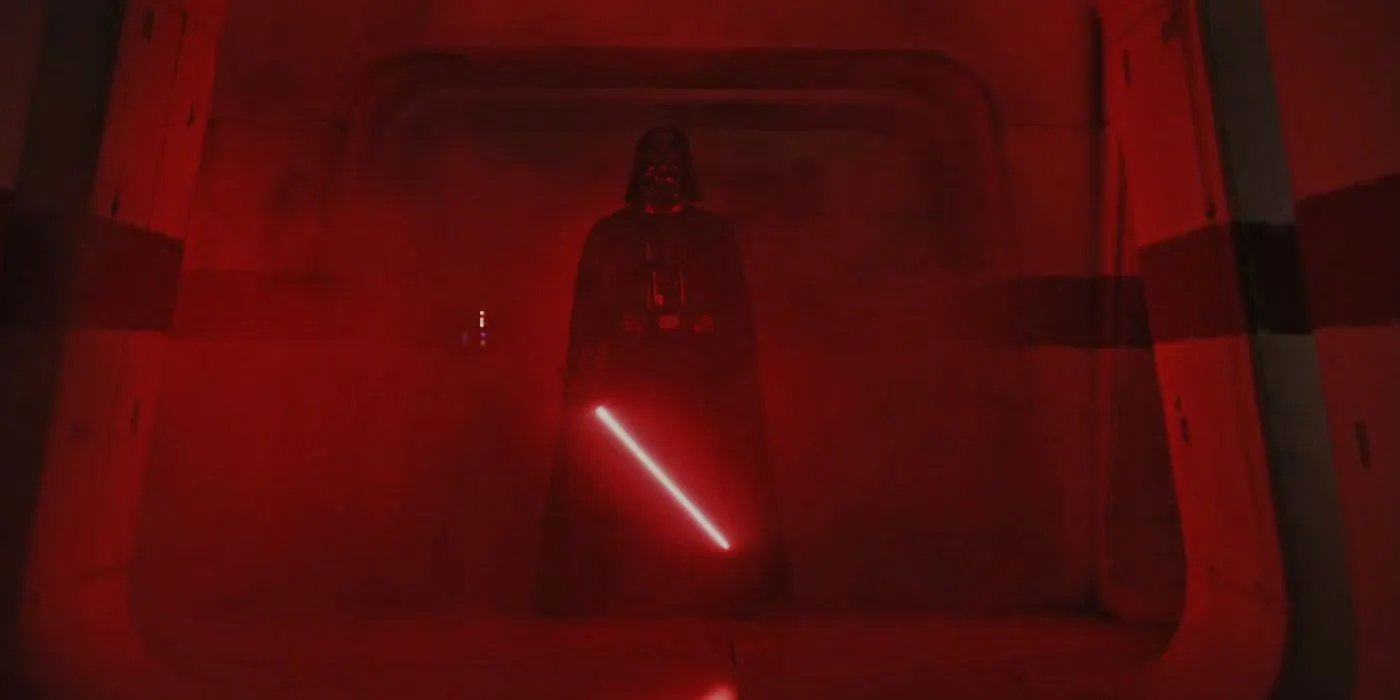 Darth Vader holding his lightsaber surrounded by red light in Rogue One: A Star Wars Story. Darth Vader holding his lightsaber surrounded by red light in Rogue One: A Star Wars Story.