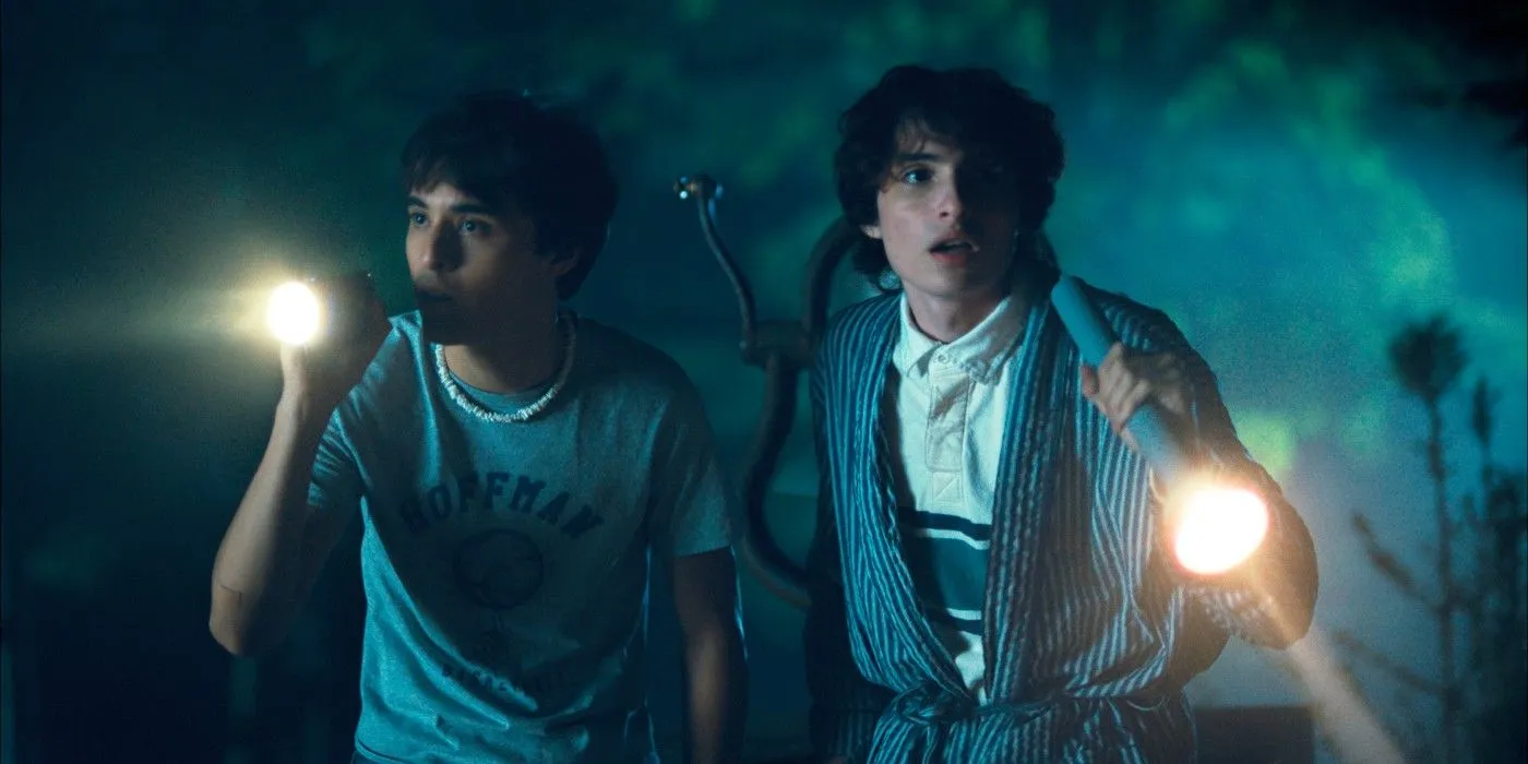 Finn Wolfhard and Billy Bryk holding flashlights in Hell of a Summer Finn Wolfhard and Billy Bryk holding flashlights in Hell of a Summer