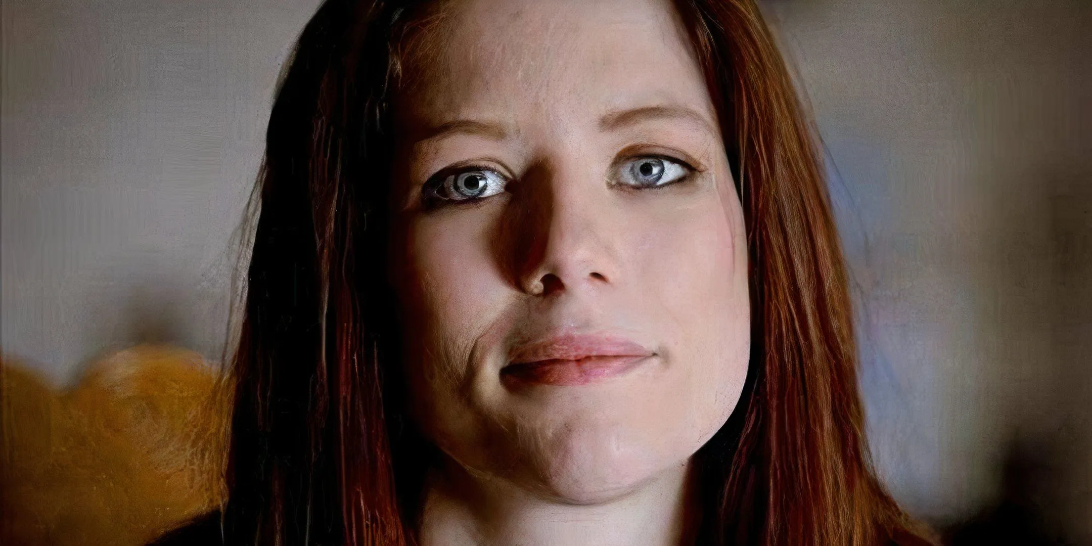 A woman looks directly at the camera with a slight smile. A woman looks directly at the camera with a slight smile.