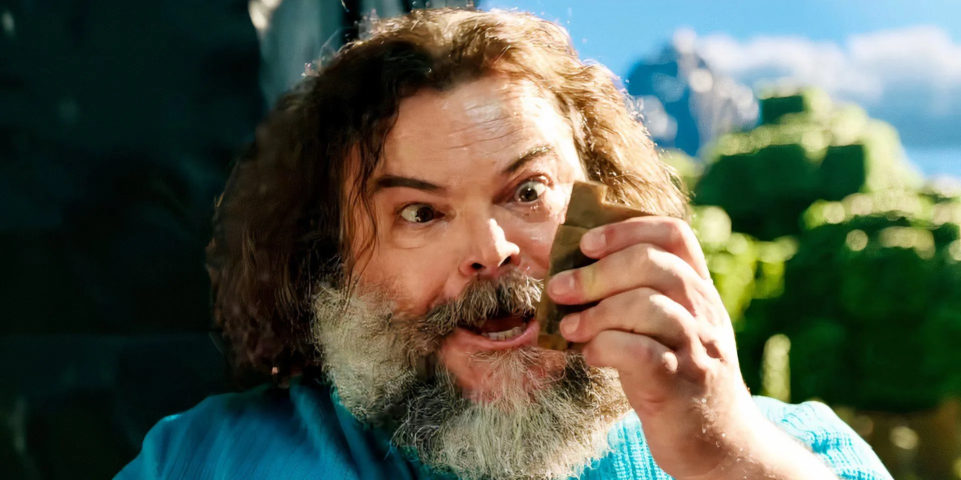 Jack Black holding a cube in A Minecraft Movie Jack Black holding a cube in A Minecraft Movie