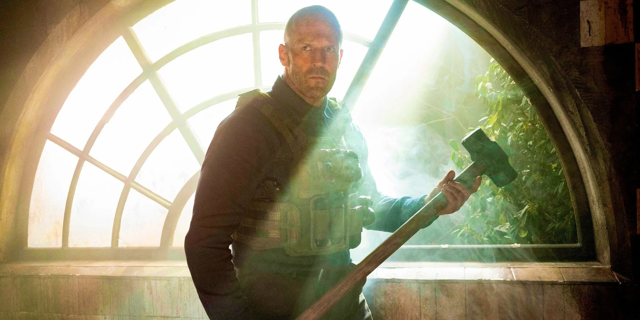 Jason Statham holding a sledgehammer