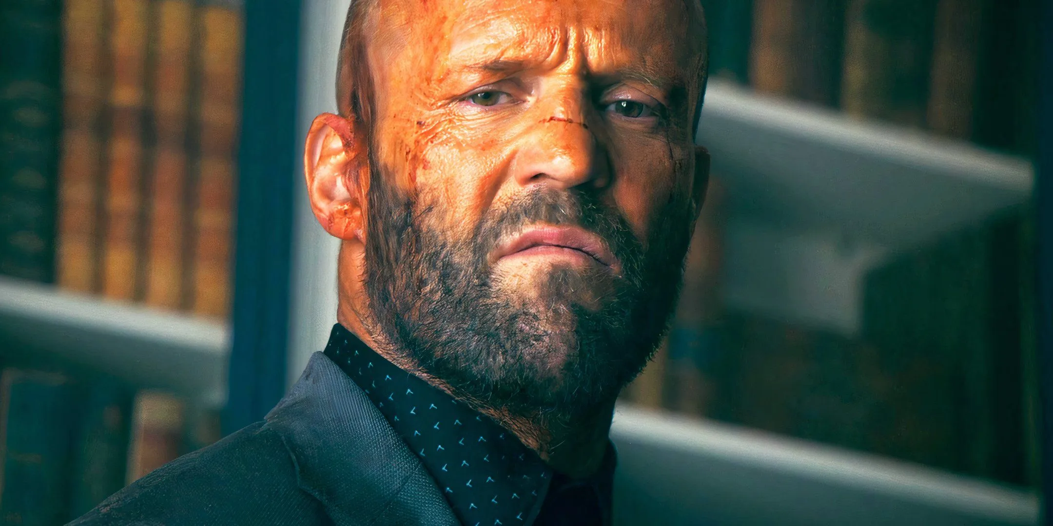 Jason Statham grimacing as Adam Clay in The Beekeeper Jason Statham grimacing as Adam Clay in The Beekeeper