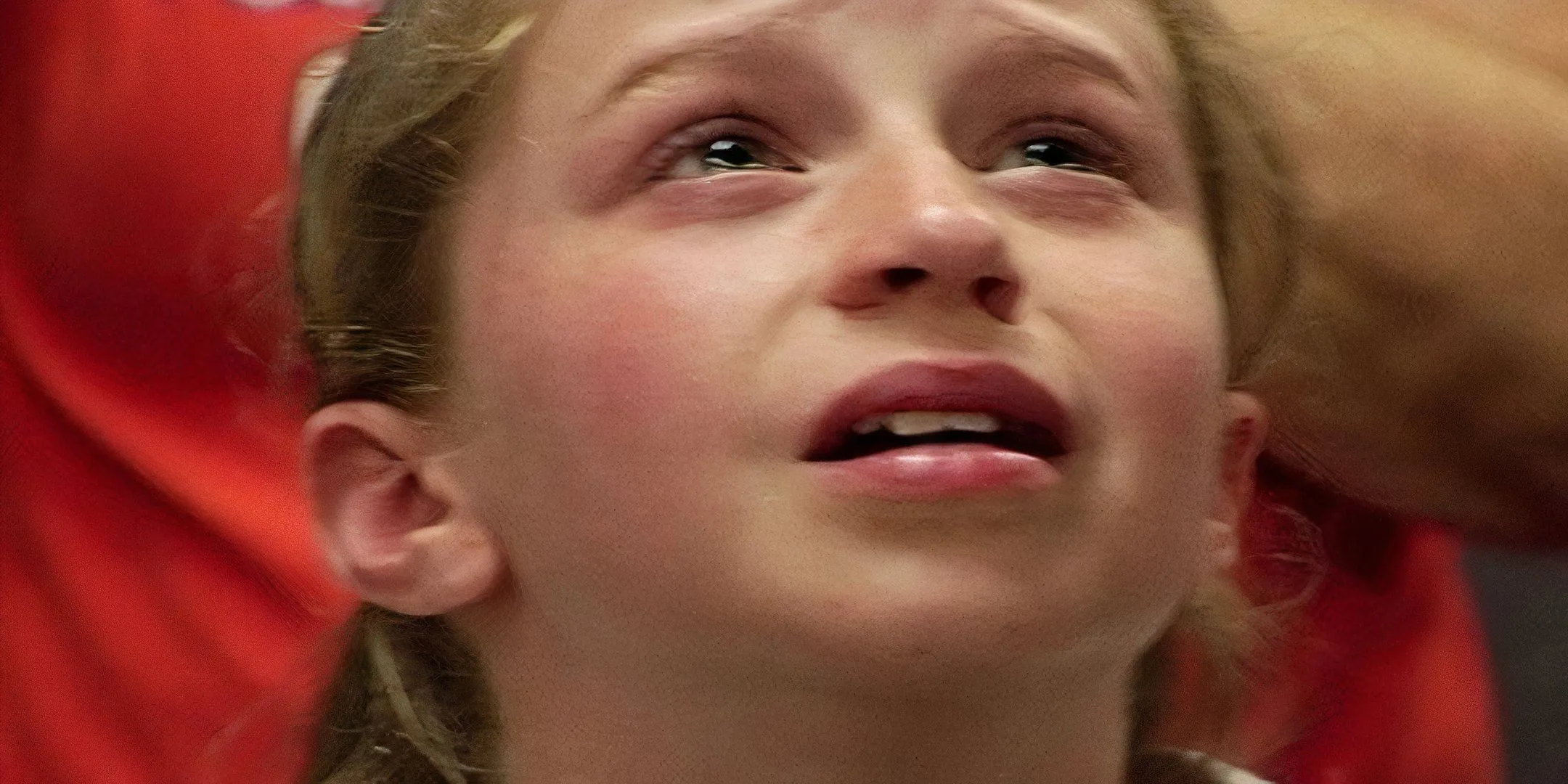 A young girl looks up at the ceiling with tears in her eyes. A young girl looks up at the ceiling with tears in her eyes.