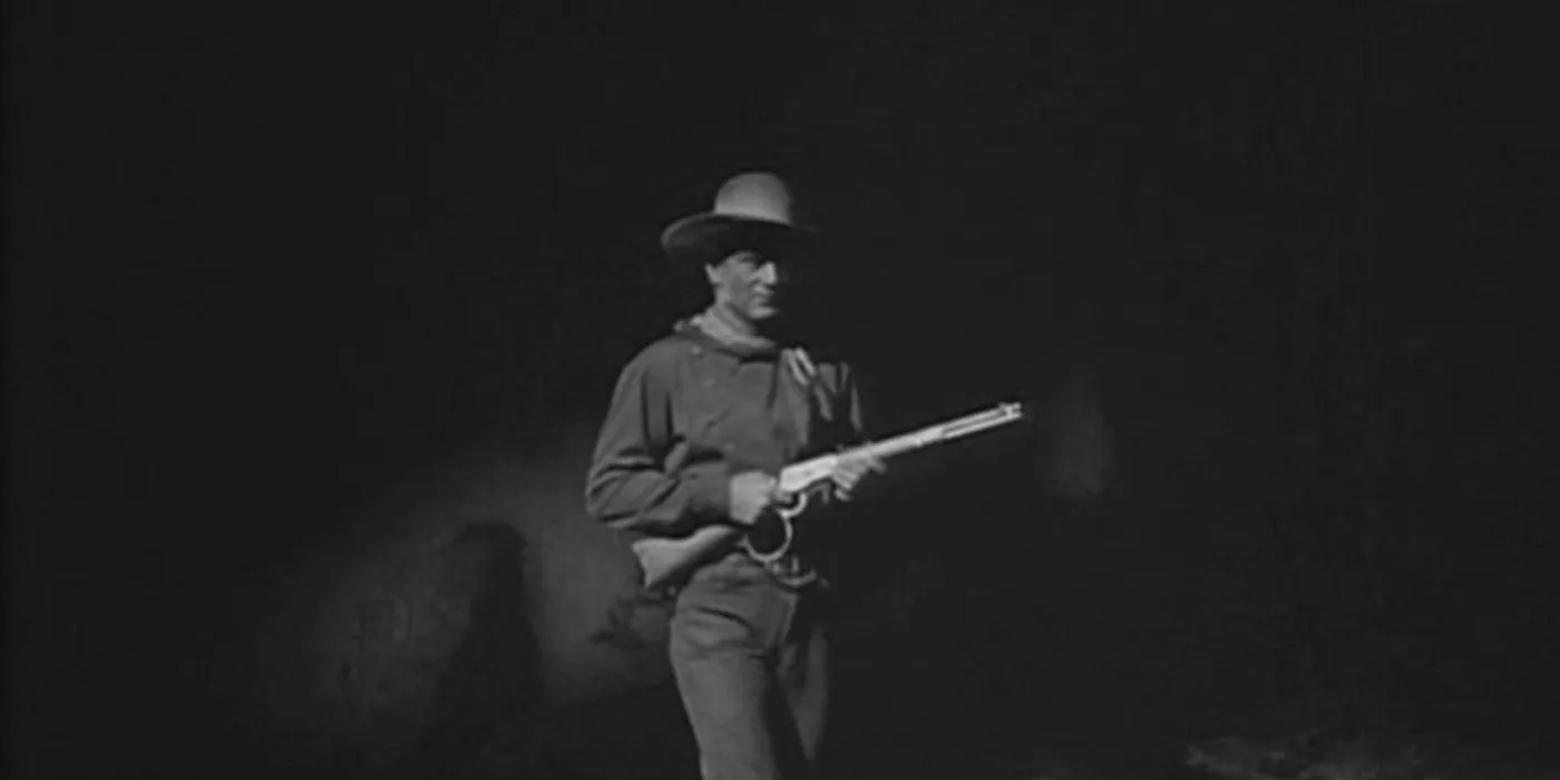 John Wayne holding a gun in Stagecoach John Wayne holding a gun in Stagecoach