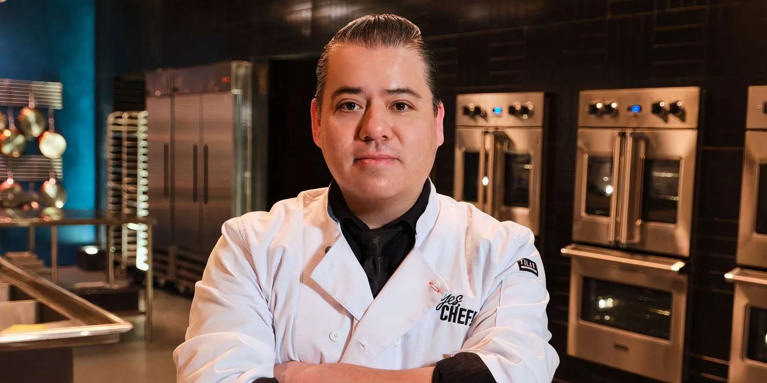 Katsuji posing with a straight face with arms crossed in a kitchen Katsuji posing with a straight face with arms crossed in a kitchen