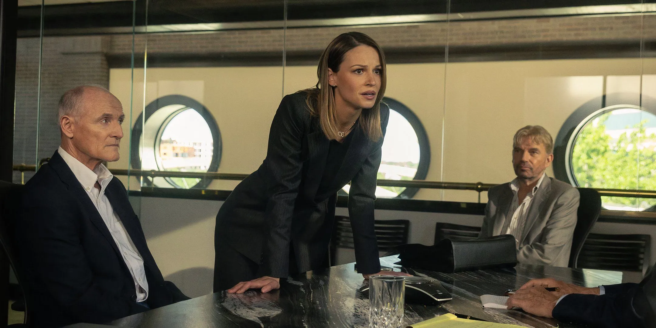 Rebecca looking angry in a meeting