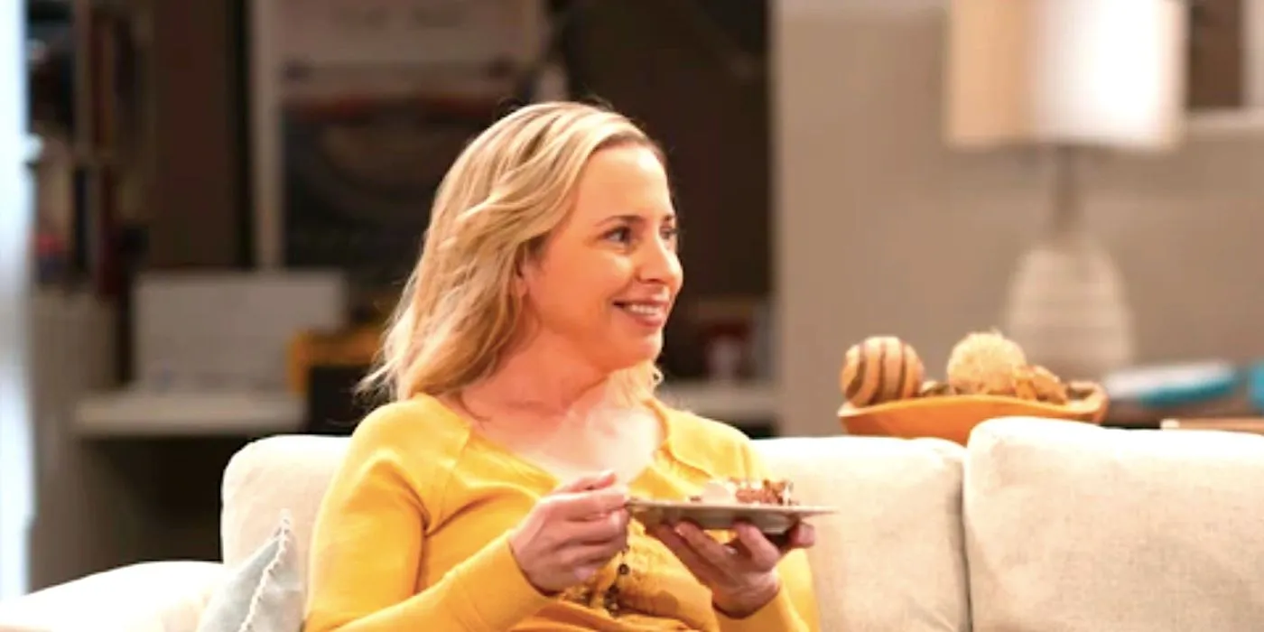 Becky smiles holding a plate of cake