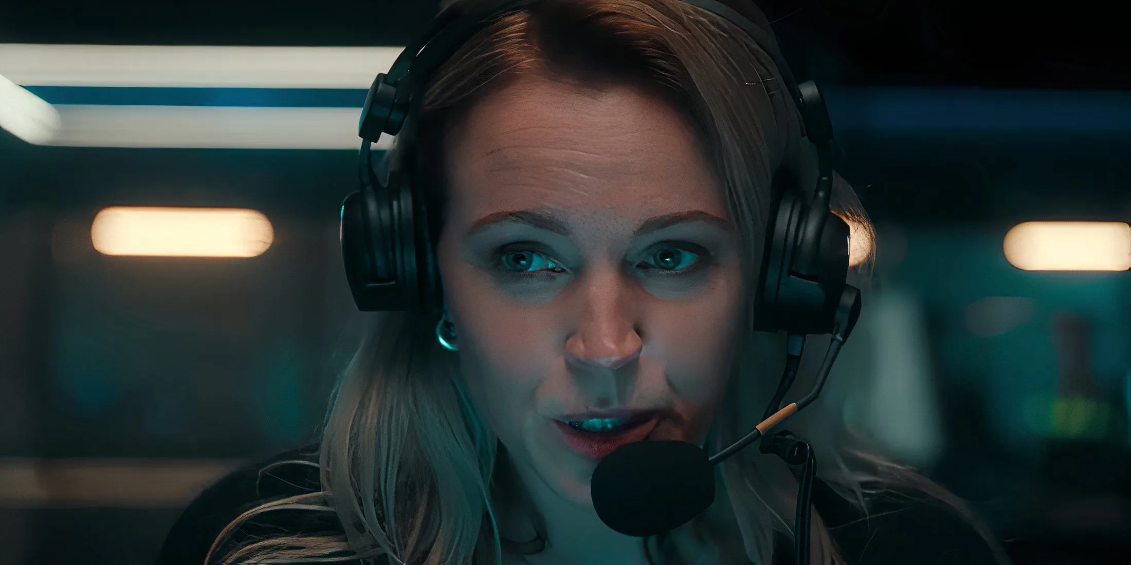 Lynn speaking into a headset in iHostage Lynn speaking into a headset in iHostage