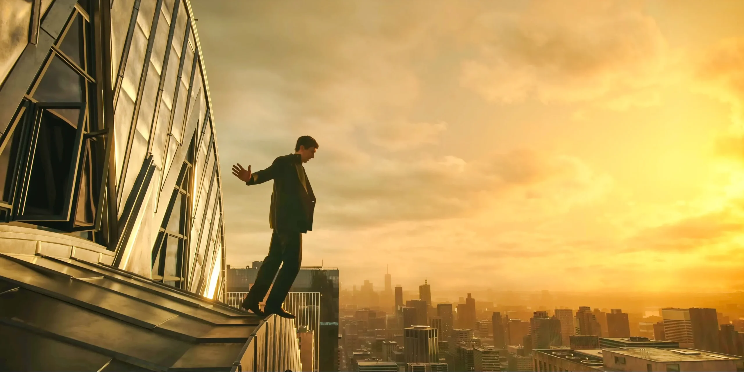 Cesar Catilina (Adam Driver) maintaining balance on top of the Chrysler building in Megalopolis