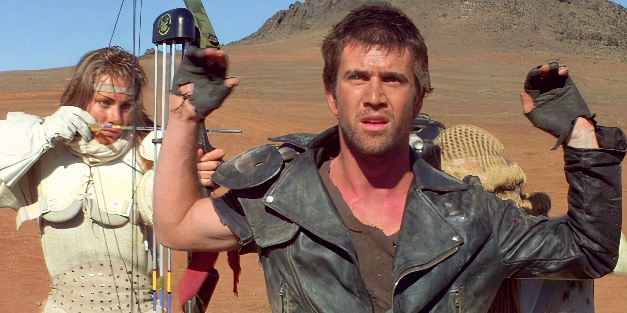 Virginia Hey threateningly points a bow and arrow at Mel Gibson. Virginia Hey threateningly points a bow and arrow at Mel Gibson.