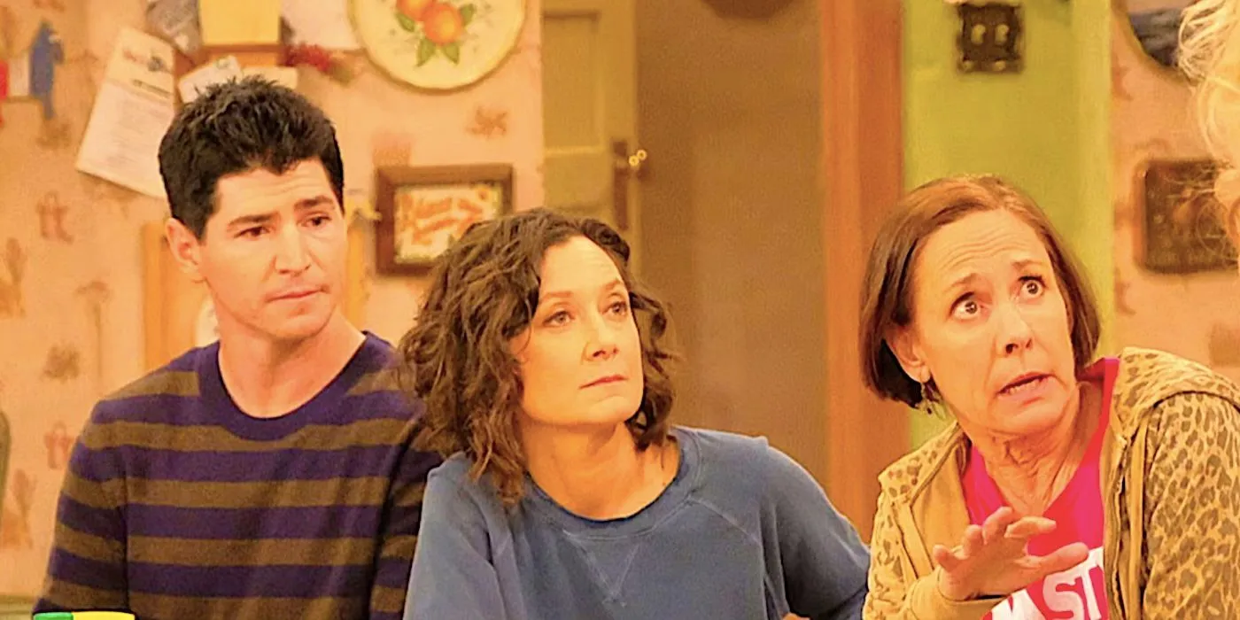 Characters from The Conners sitting at a kitchen table Characters from The Conners sitting at a kitchen table