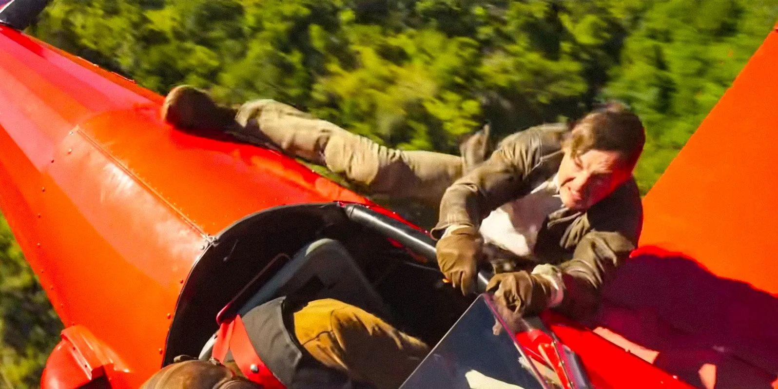 Ethan Hunt (Tom Cruise) clinging to a small aircraft in flight in Mission: Impossible - The Final Reckoning