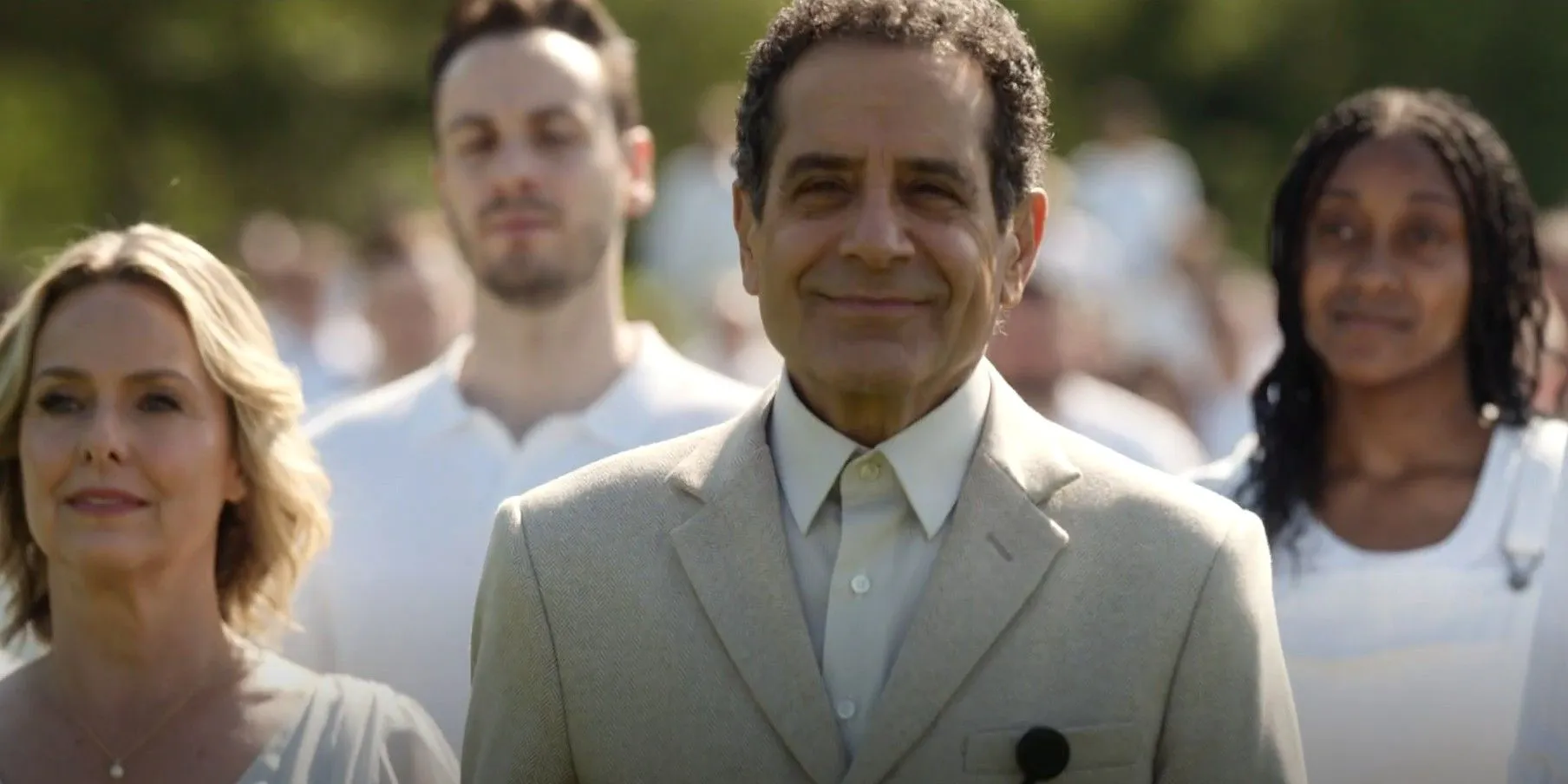 Adrian Monk (Tony Shalhoub) smiling while walking with a crowd dressed in white in Mr. Monk's Last Case: A Monk Movie Adrian Monk (Tony Shalhoub) smiling while walking with a crowd dressed in white in Mr. Monk's Last Case: A Monk Movie