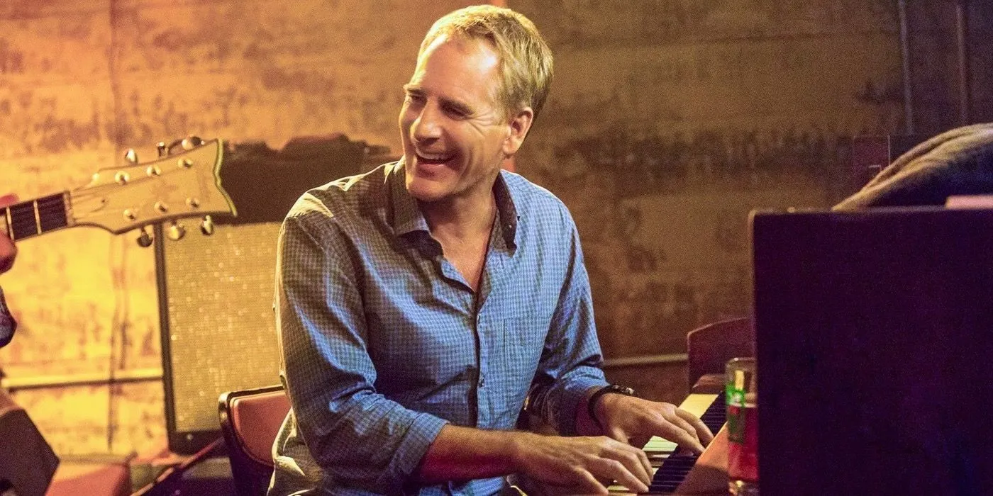 Scott Bakula as Pride playing the piano