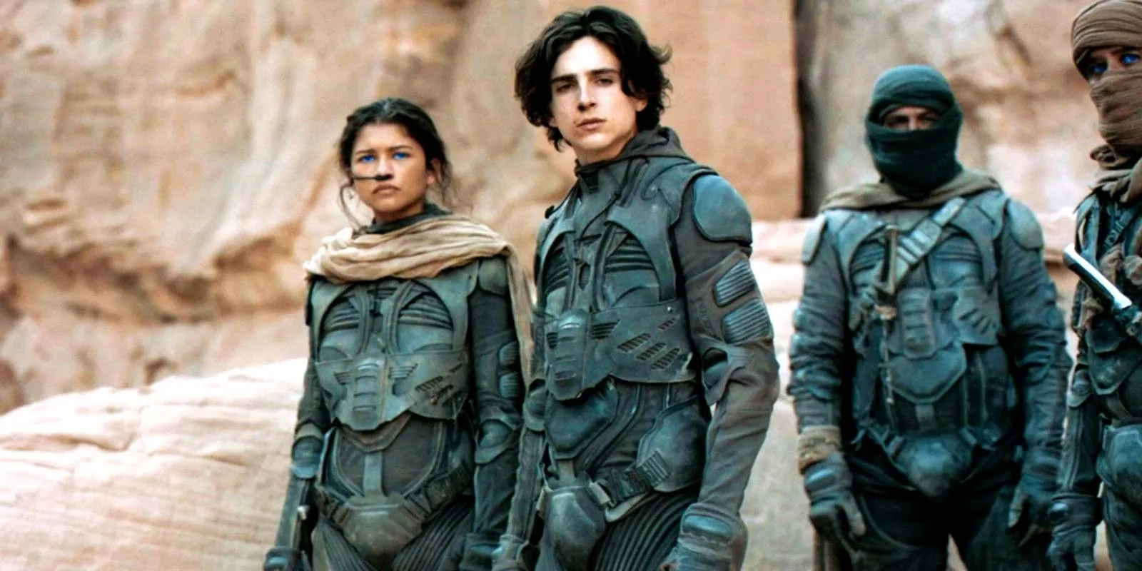 Paul Atreides and Chani on a rock surrounded by Fremen Paul Atreides and Chani on a rock surrounded by Fremen