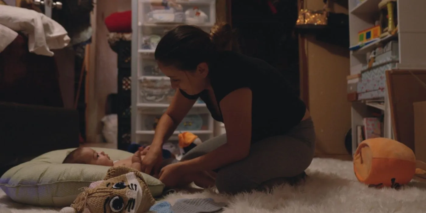 Preconceived woman tending to baby on the floor