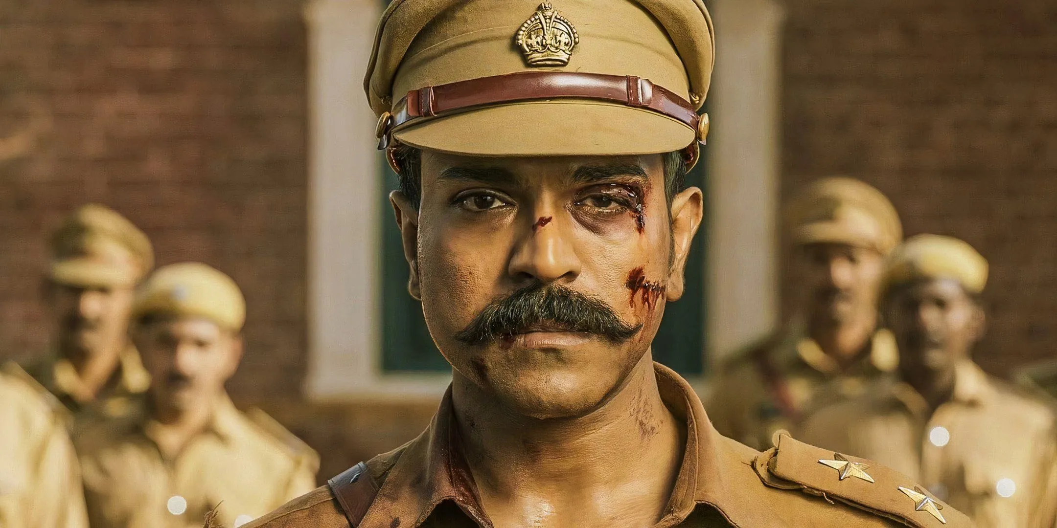 One of Ram Charan's eyes is bloodied as he stares into the camera with a sad look. One of Ram Charan's eyes is bloodied as he stares into the camera with a sad look.