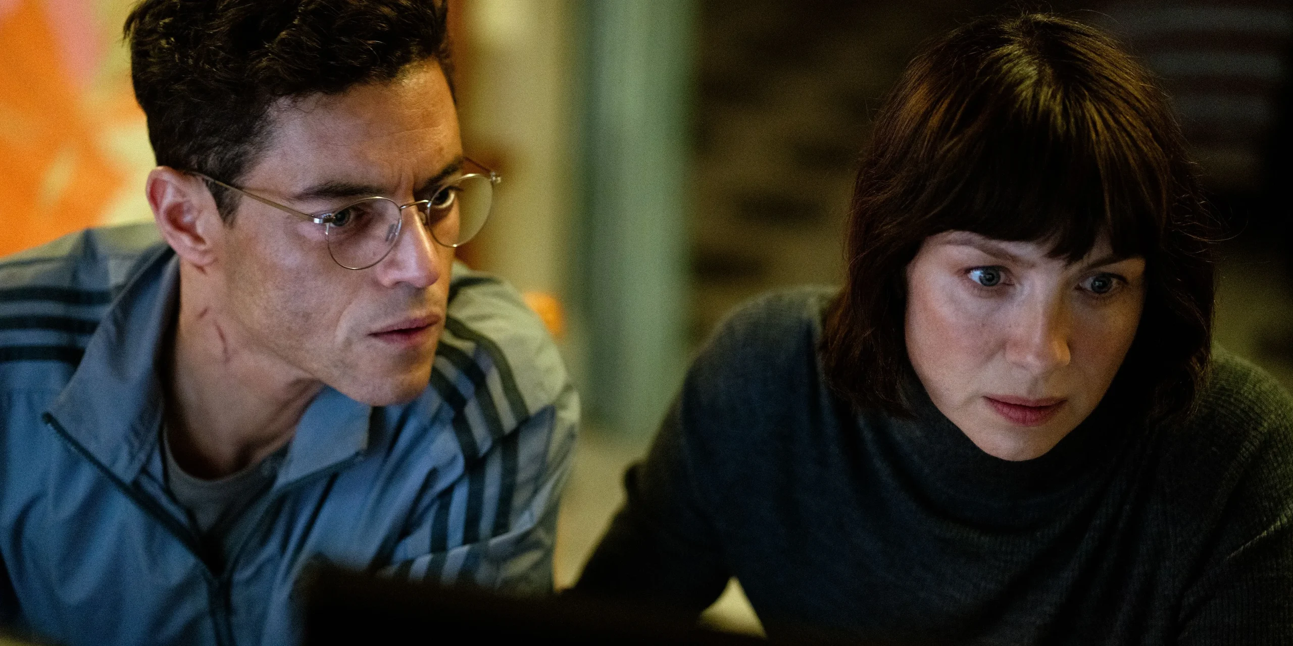 Rami Malek & Caitriona Balfe looking at a screen in The Amateur Rami Malek & Caitriona Balfe looking at a screen in The Amateur