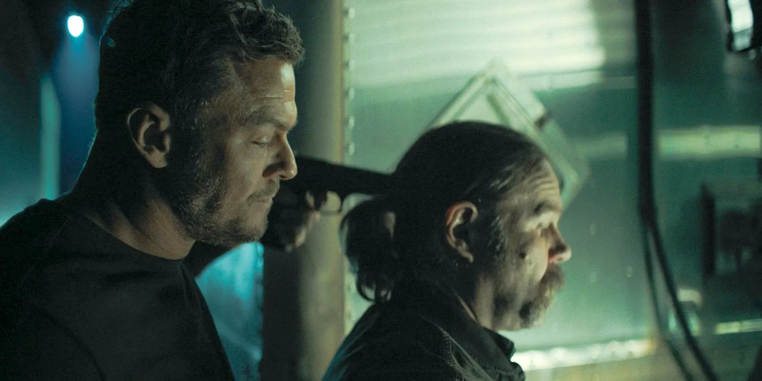 Jack Reacher (Alan Ritchson) holding a gun to a man's head in Reacher Season 3 Ep 8