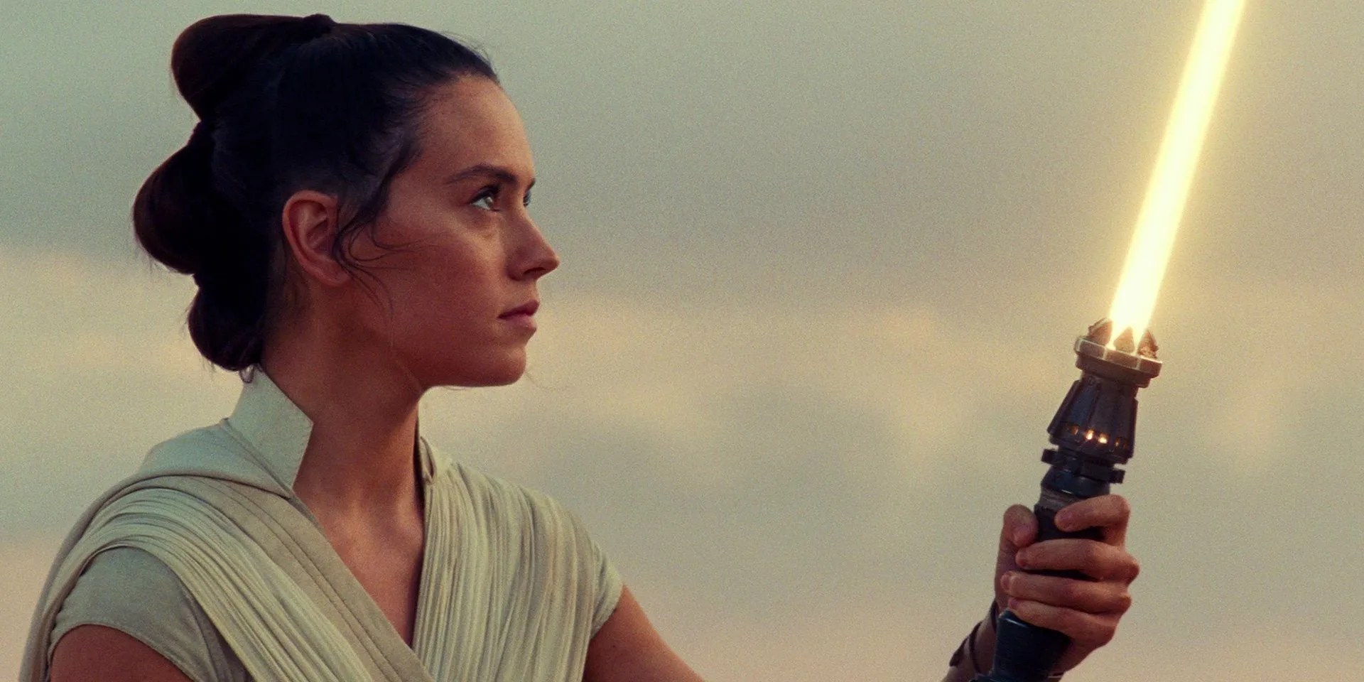 Rey with her yellow lightsaber