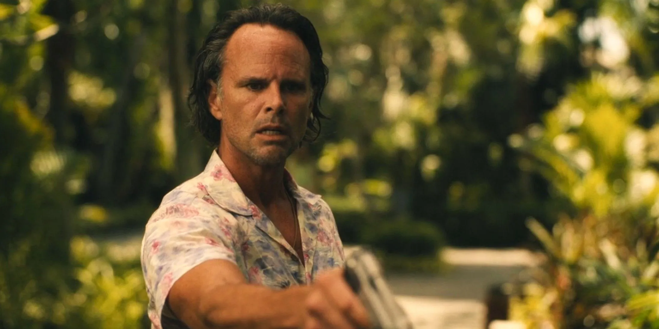Rick pointing a gun after shooting Jim
