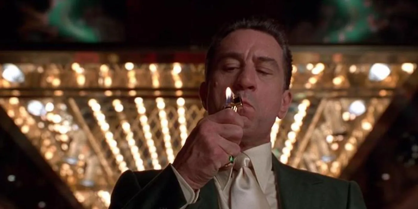 Robert De Niro as Sam 'Ace' Rothstein lighting a cigarette in a casino in Casino Robert De Niro as Sam 'Ace' Rothstein lighting a cigarette in a casino in Casino