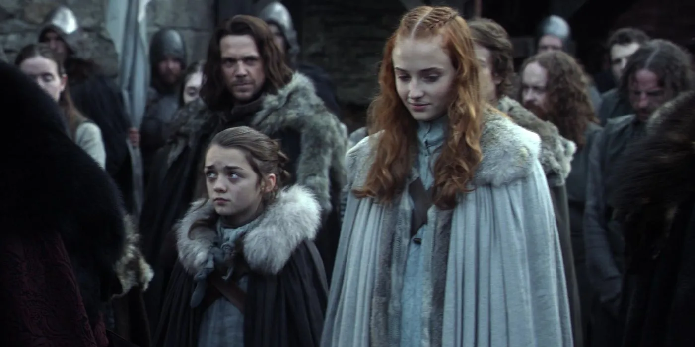 Sansa and Arya Stark standing in Winterfell's courtyard in Game of Thrones season 1 episode 1 Sansa and Arya Stark standing in Winterfell's courtyard in Game of Thrones season 1 episode 1