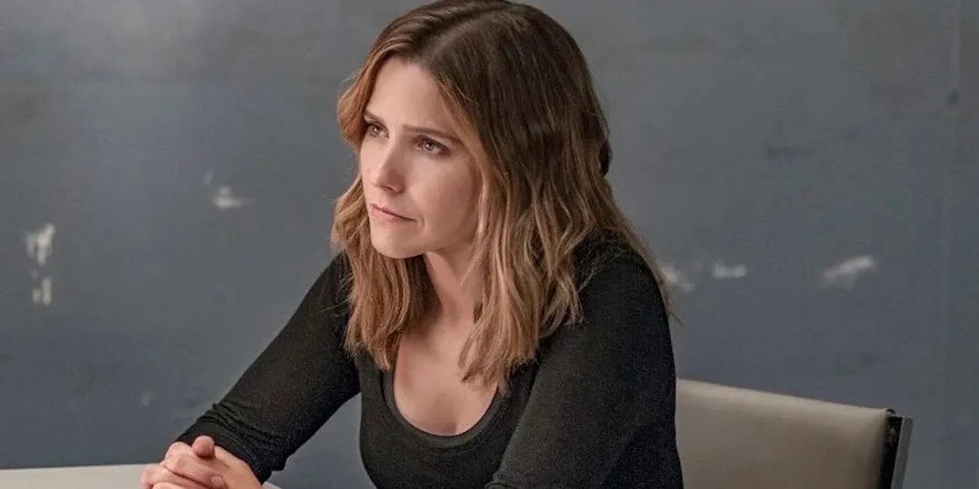 Erin Lindsay sitting at interrogation table with hands interlocked in Chicago PD Erin Lindsay sitting at interrogation table with hands interlocked in Chicago PD