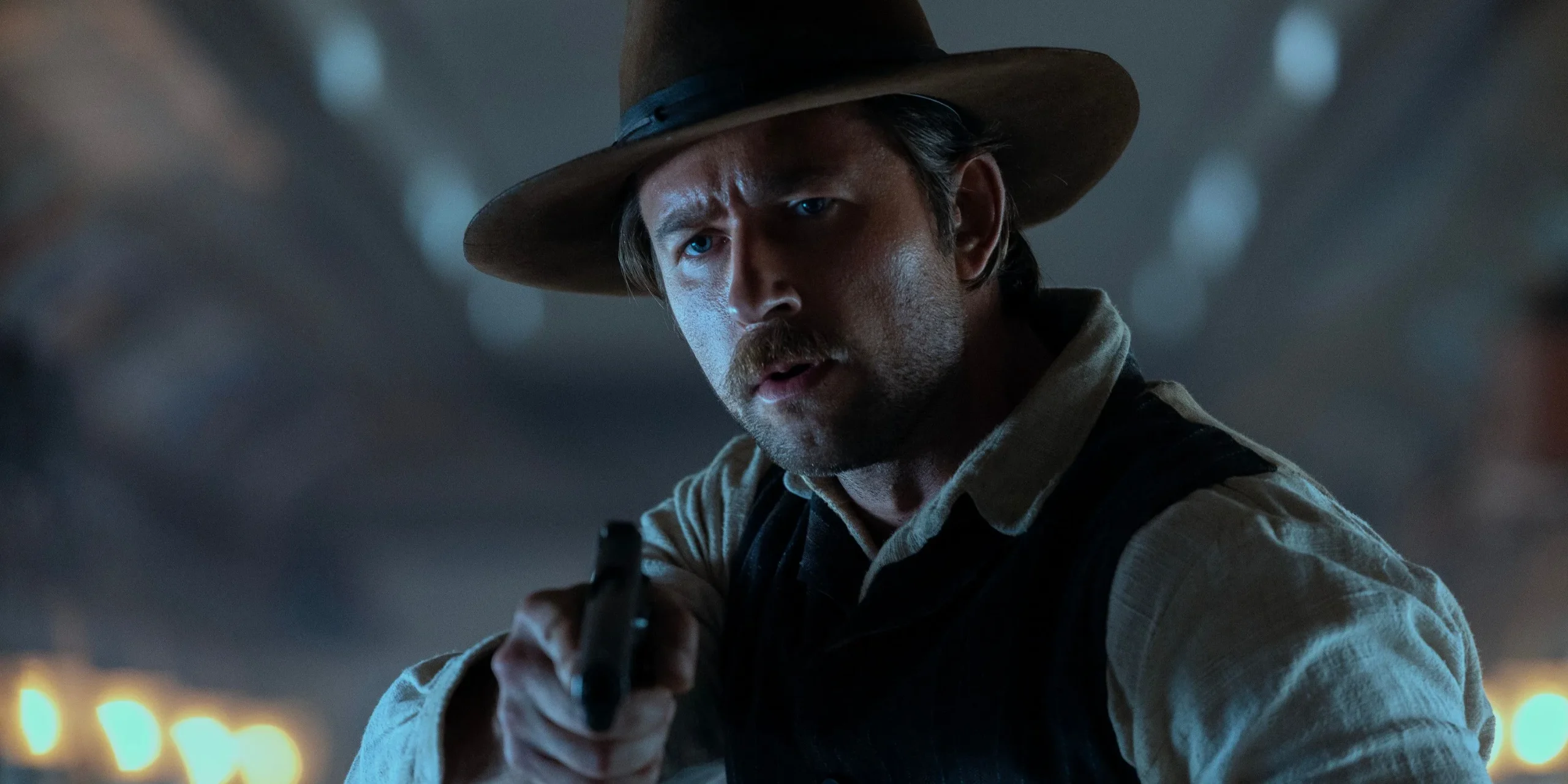 Spencer aims a gun