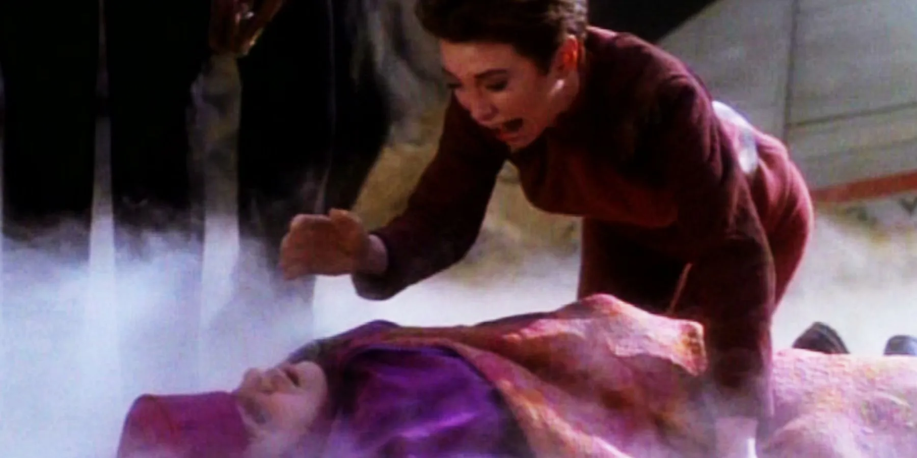 Kira leans over the body of Kai Opaka, crying out in grief Kira leans over the body of Kai Opaka, crying out in grief