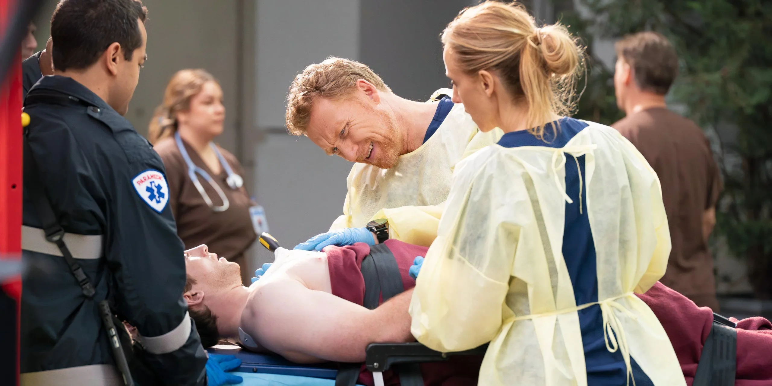 Teddy and Owen stand over a patient in Grey's Anatomy season 21 episode 14