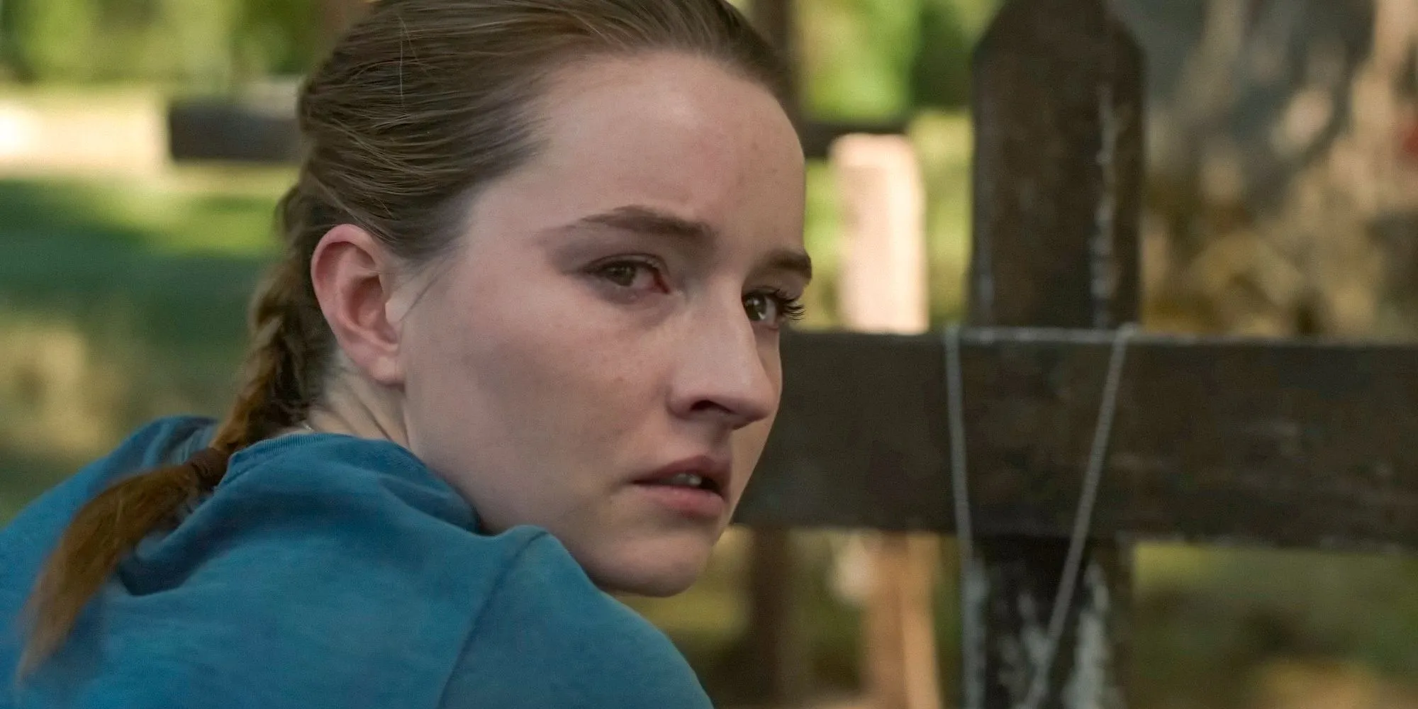 Abby Anderson (Kaitlyn Dever) kneeling in front of a grave in The Last of Us Season 2
