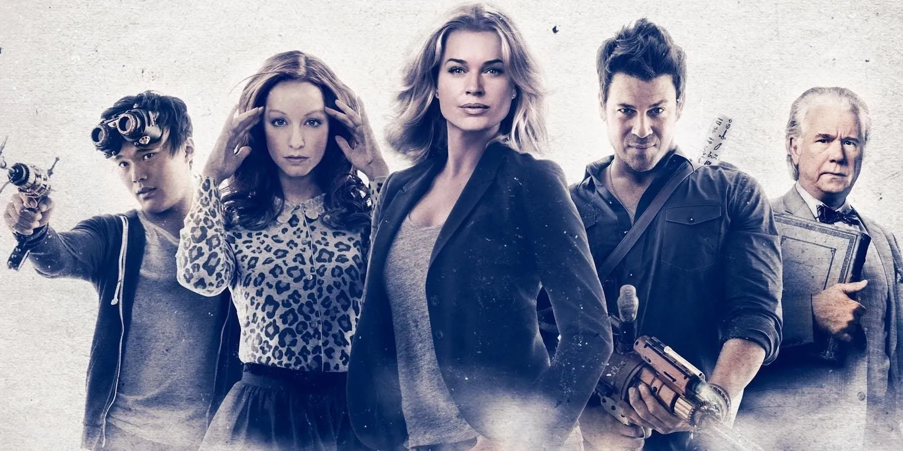 The cast of The Librarians poses in front of a white background with a blue tint