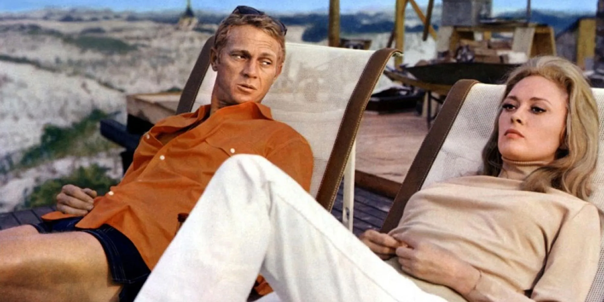Steve McQueen and Faye Dunaway lounge on beach chairs in The Thomas Crown Affair