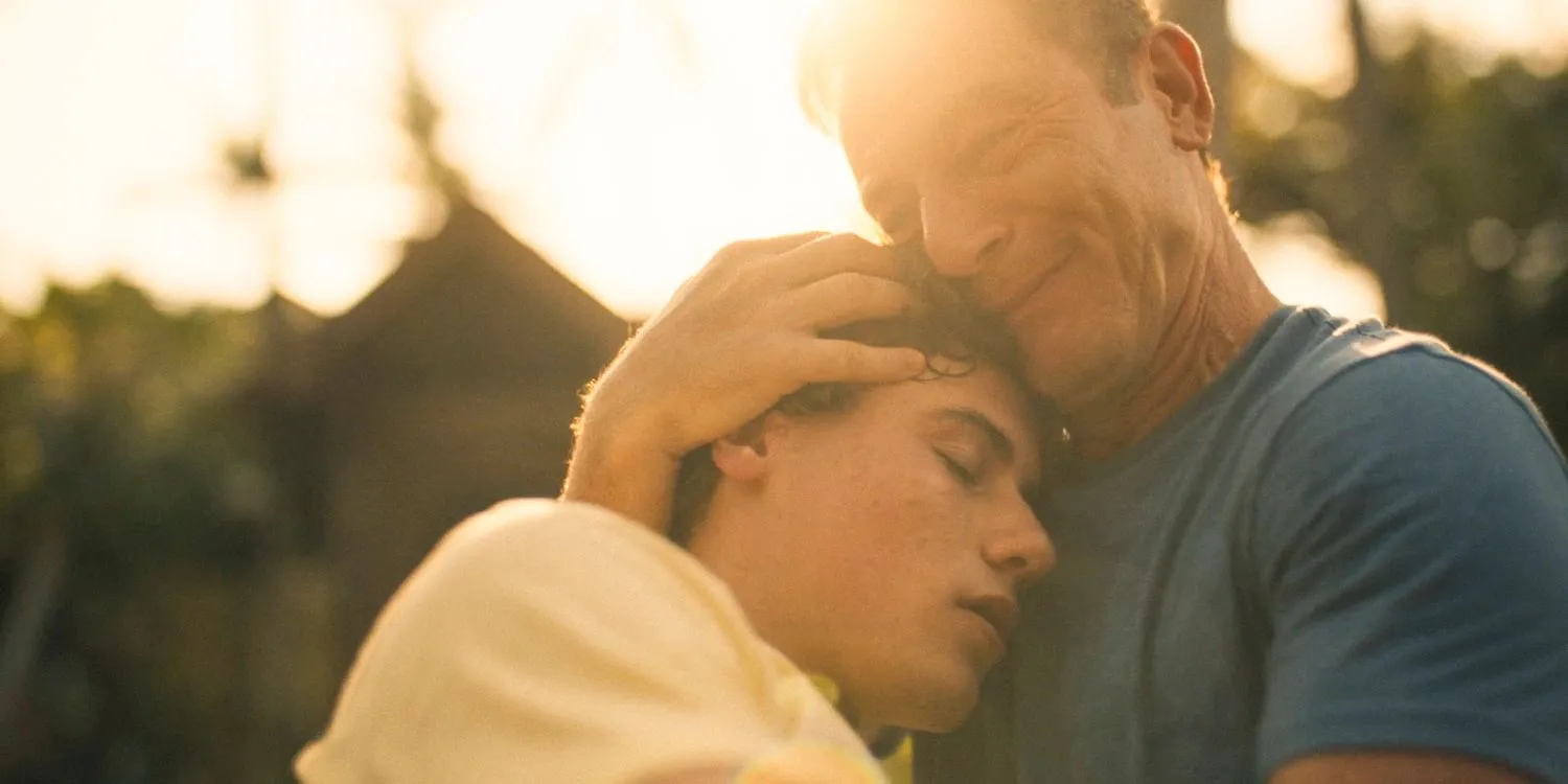 Timothy (Jason Isaacs) holding Lochlan (Sam Nivola) in his lap in The White Lotus Season 3 Ep 8 Timothy (Jason Isaacs) holding Lochlan (Sam Nivola) in his lap in The White Lotus Season 3 Ep 8
