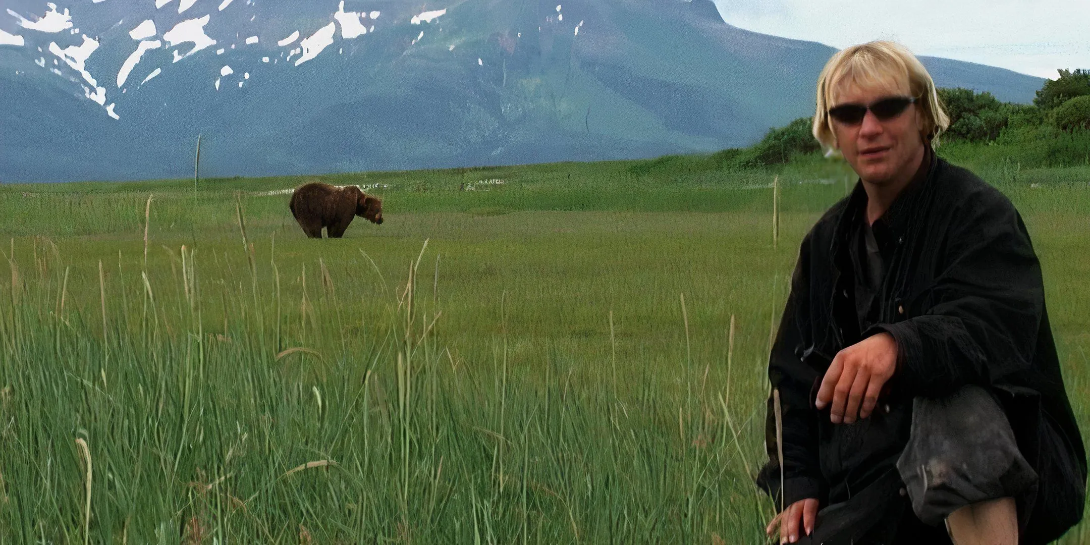 Timothy Treadwell poses with a bear from a distance. Timothy Treadwell poses with a bear from a distance.