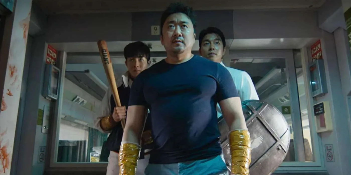 Sang-hwa stands centre frame, his arms wrapped in tape looking ahead in Train to Busan.