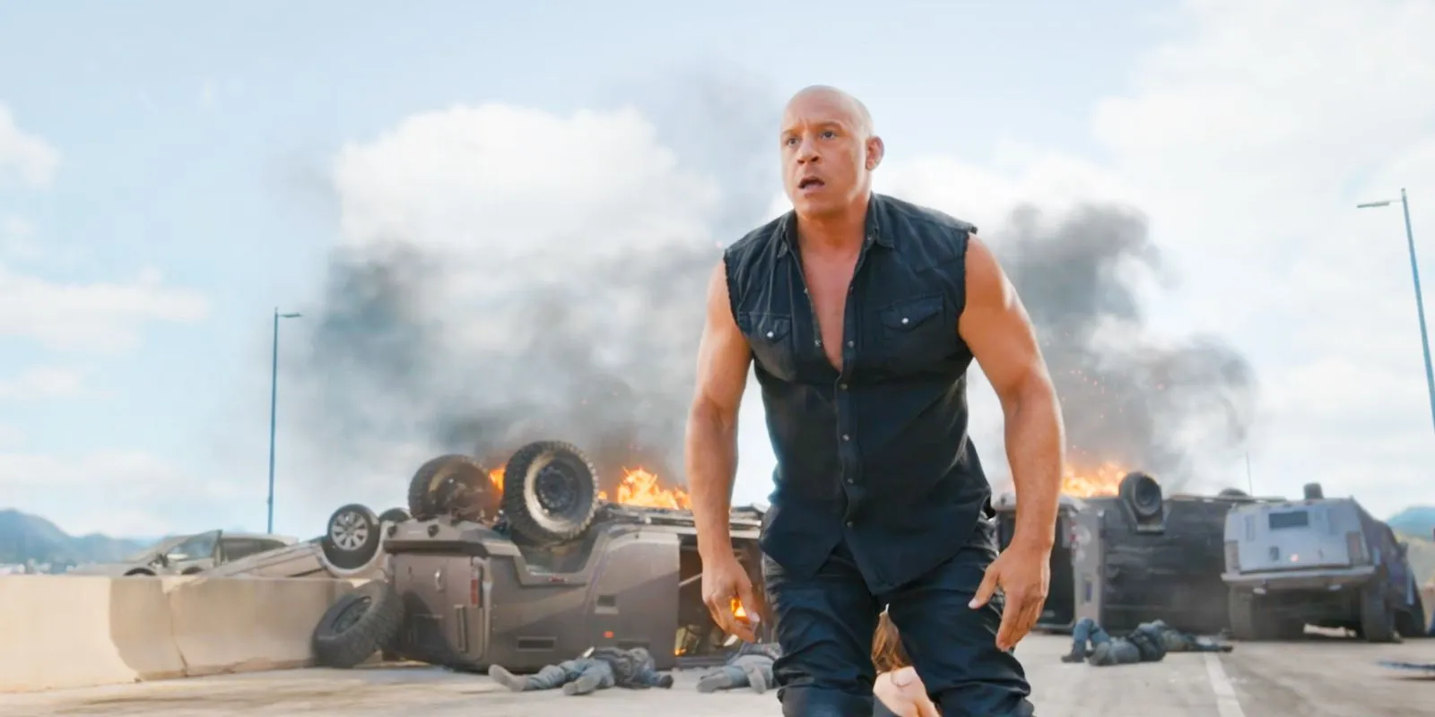 Dominic Toretto standing in front of fire