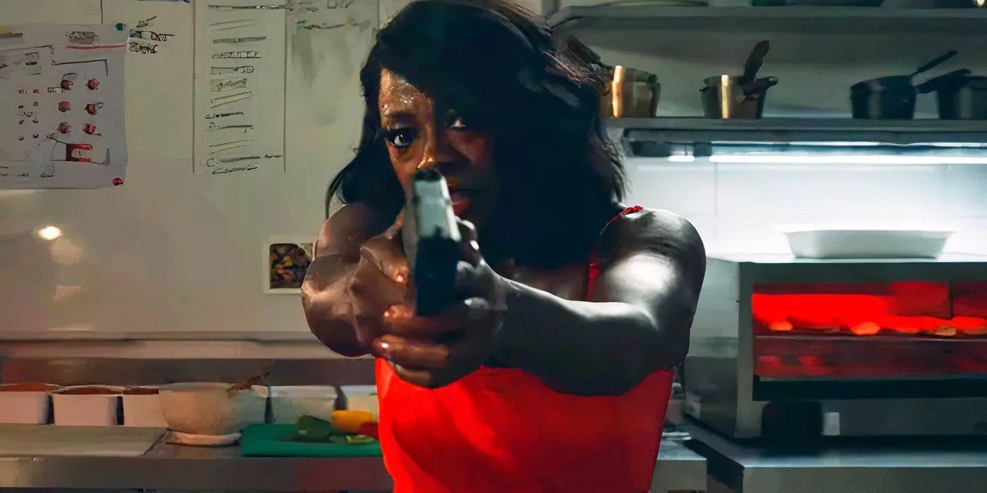 Viola Davis pointing a gun while wearing a red dress in G20 Viola Davis pointing a gun while wearing a red dress in G20