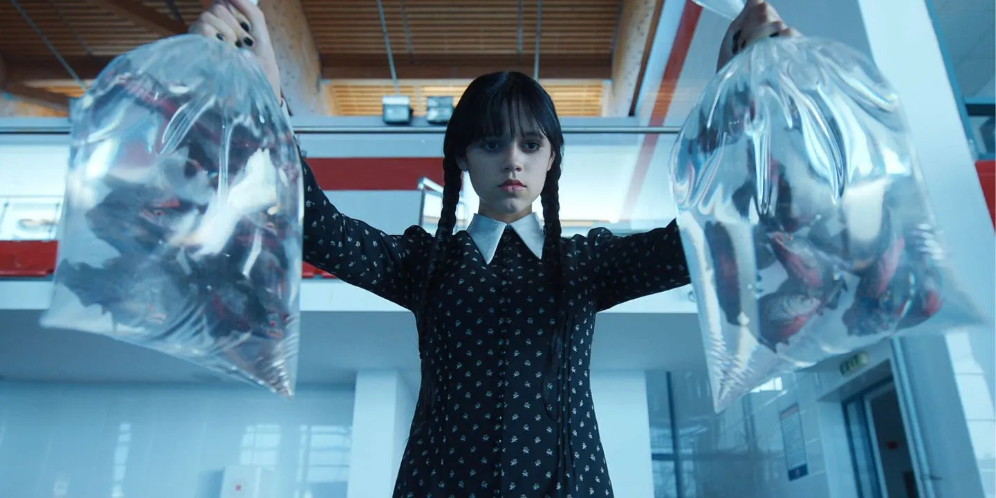 Wednesday lifts two plastic bags full of piranhas. Wednesday lifts two plastic bags full of piranhas.