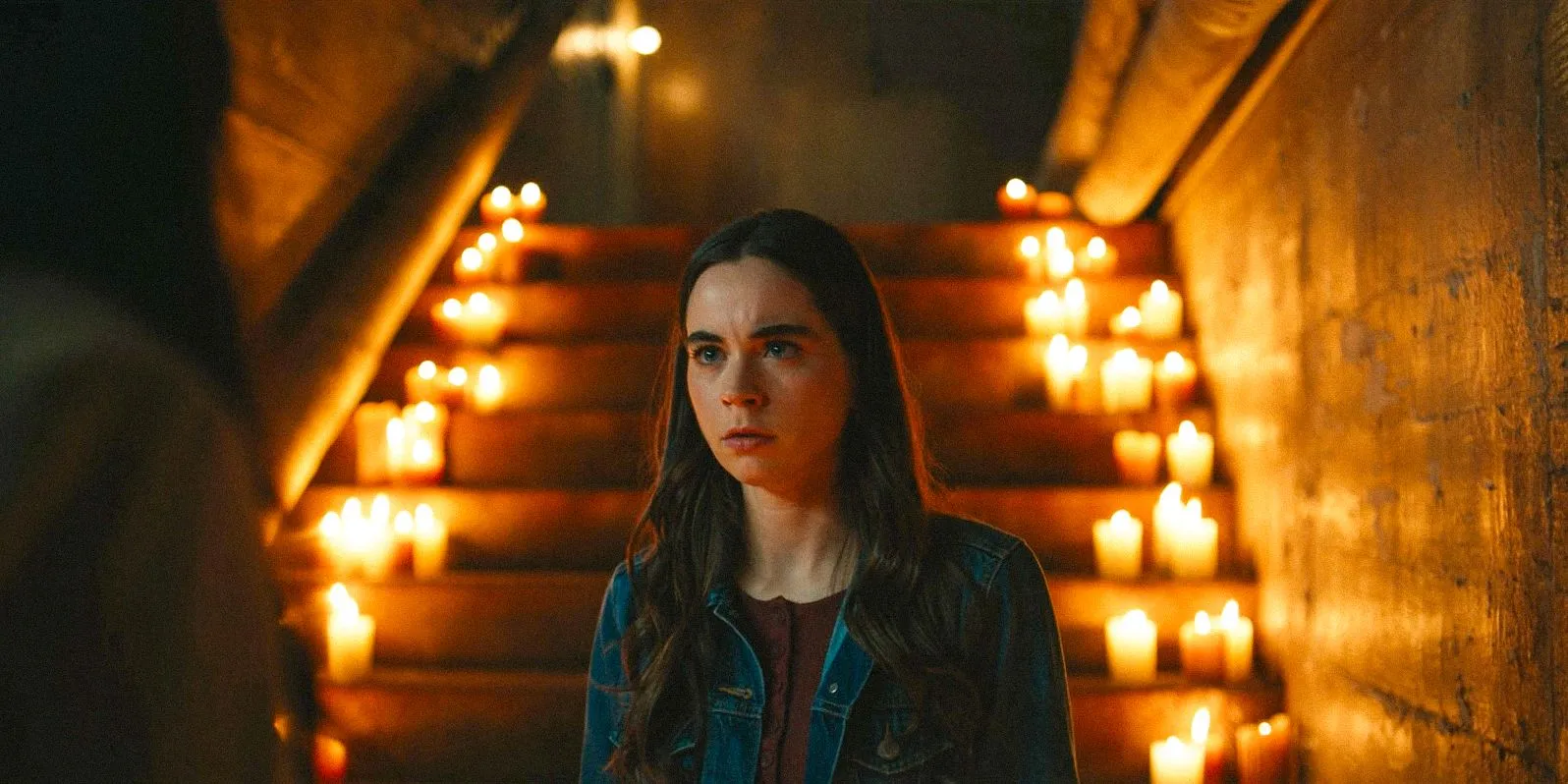 Callie (Sarah Desjardins) converses with Lottie (Simone Kessell) amidst candles in the finale of Yellowjackets season 3