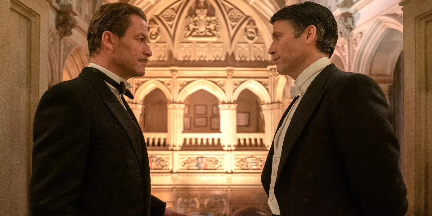 Guy and Dexter chat in the doorway of a theater in Downton Abbey: A New Era Guy and Dexter chat in the doorway of a theater in Downton Abbey: A New Era