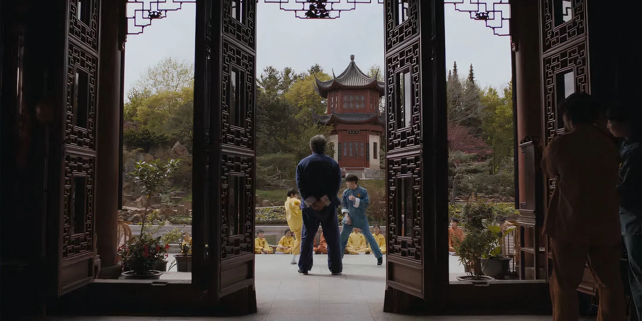 Mr. Han observing students sparring in Karate Kid: Legends