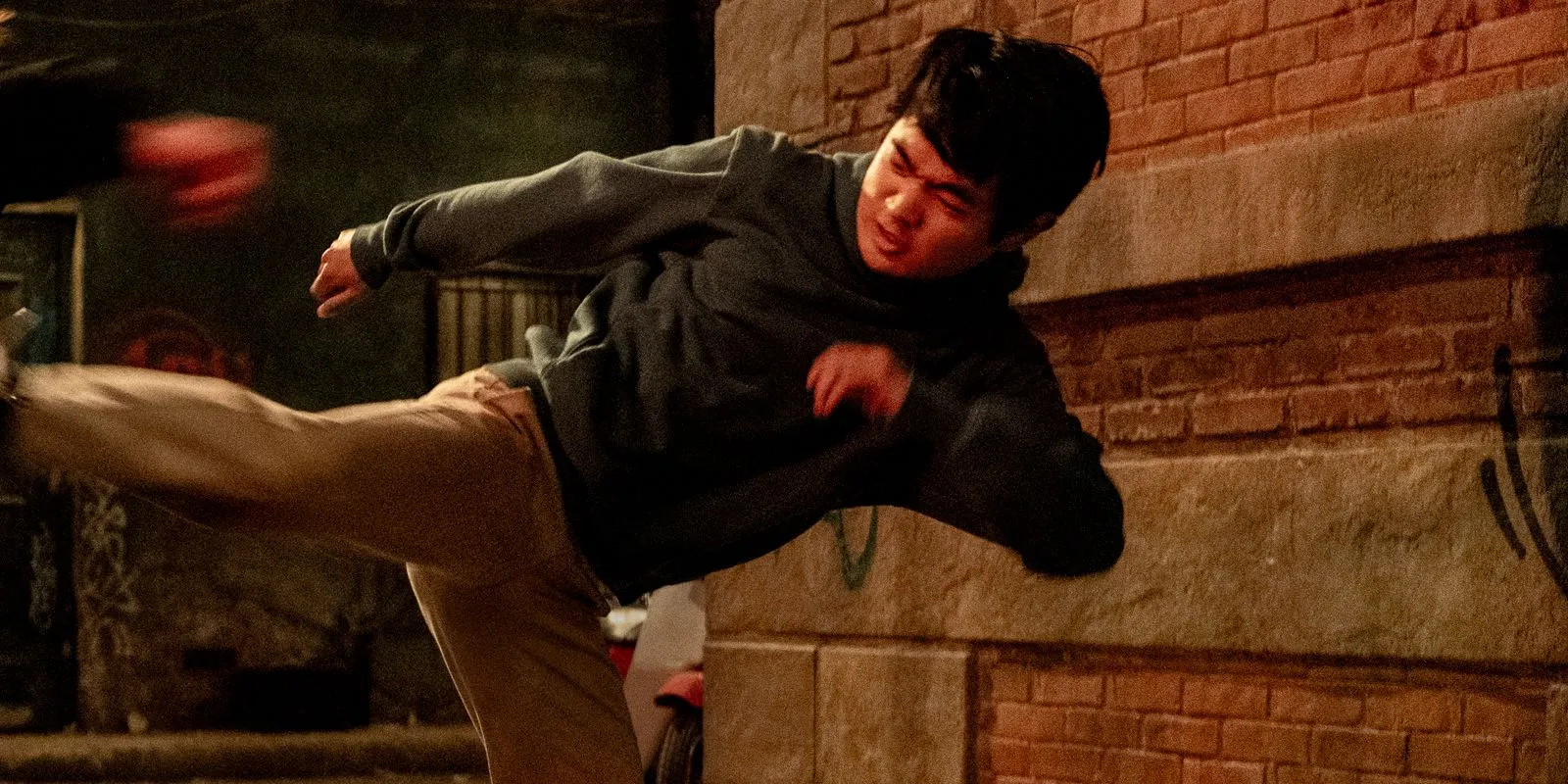 Ben Wang performing a kick with intensity in Karate Kid: Legends