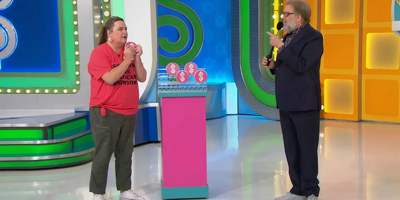 Drew Carey and a contestant with Plinko chips