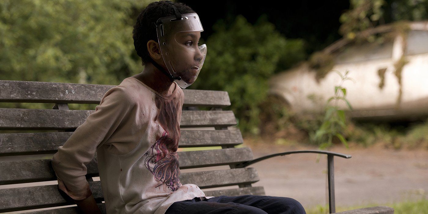 Sennia Nanua as Melanie sitting on a bench in The Girl with All the Gifts