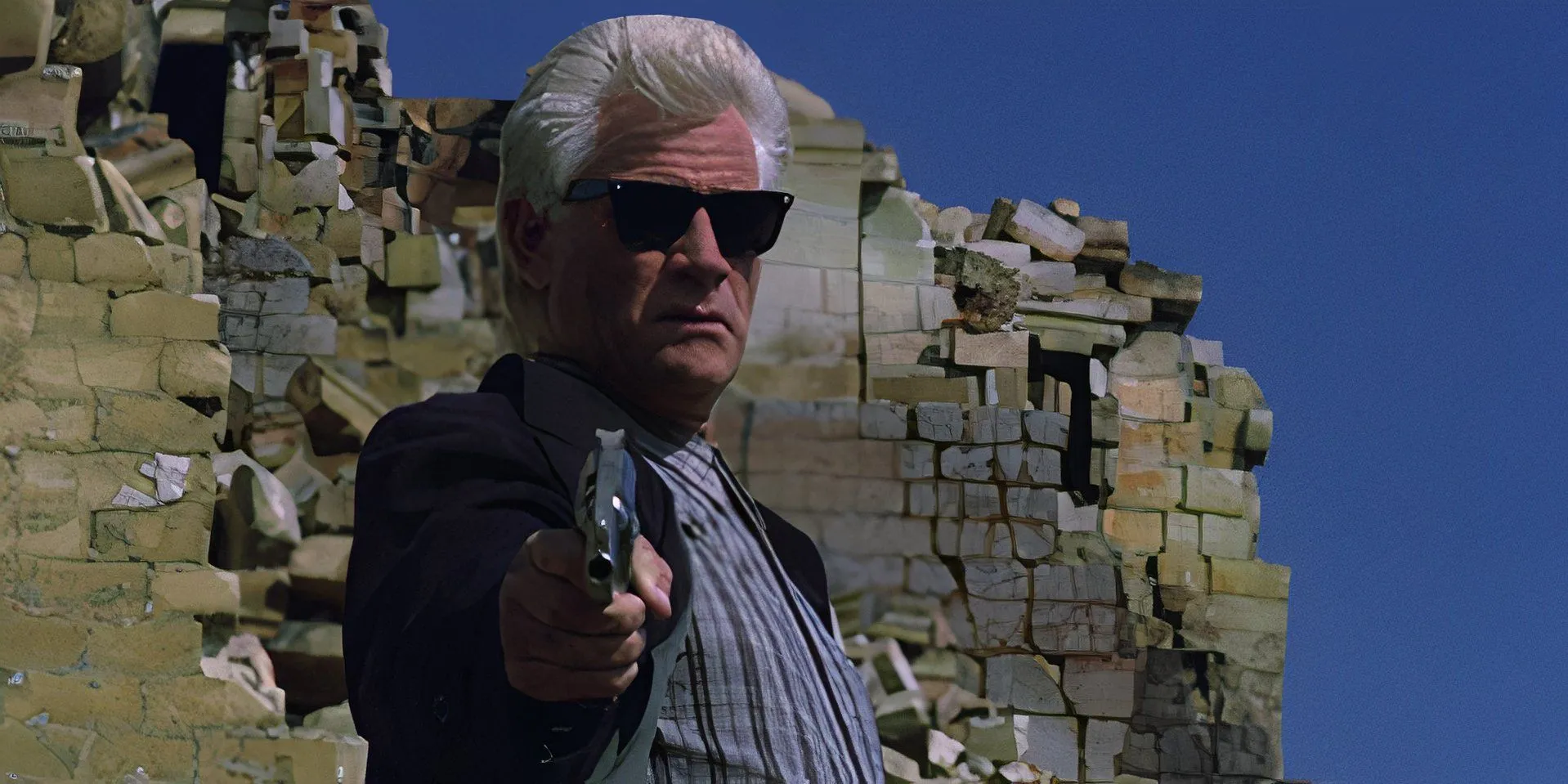 Tim Thomerson as Brick Bardo holding a gun in Dollman Tim Thomerson as Brick Bardo holding a gun in Dollman